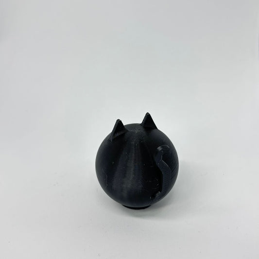 Black cat-shaped object on a white background